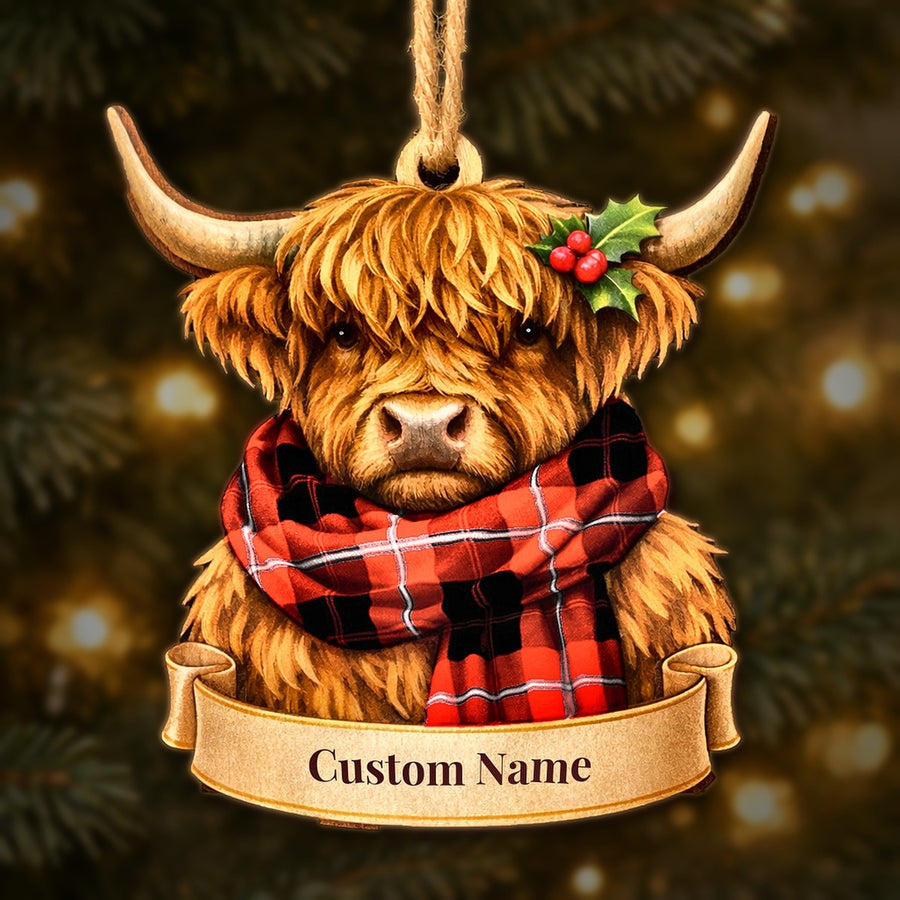 Wooden Highland cow Christmas ornament wearing a Cunningham Modern tartan scarf, with a ribbon banner for a custom name