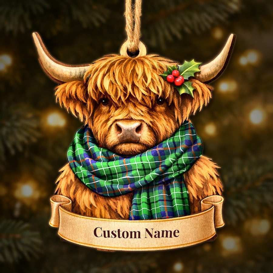 Wooden Highland cow Christmas ornament wearing a Duncan Ancient tartan scarf, with a ribbon banner for a custom name