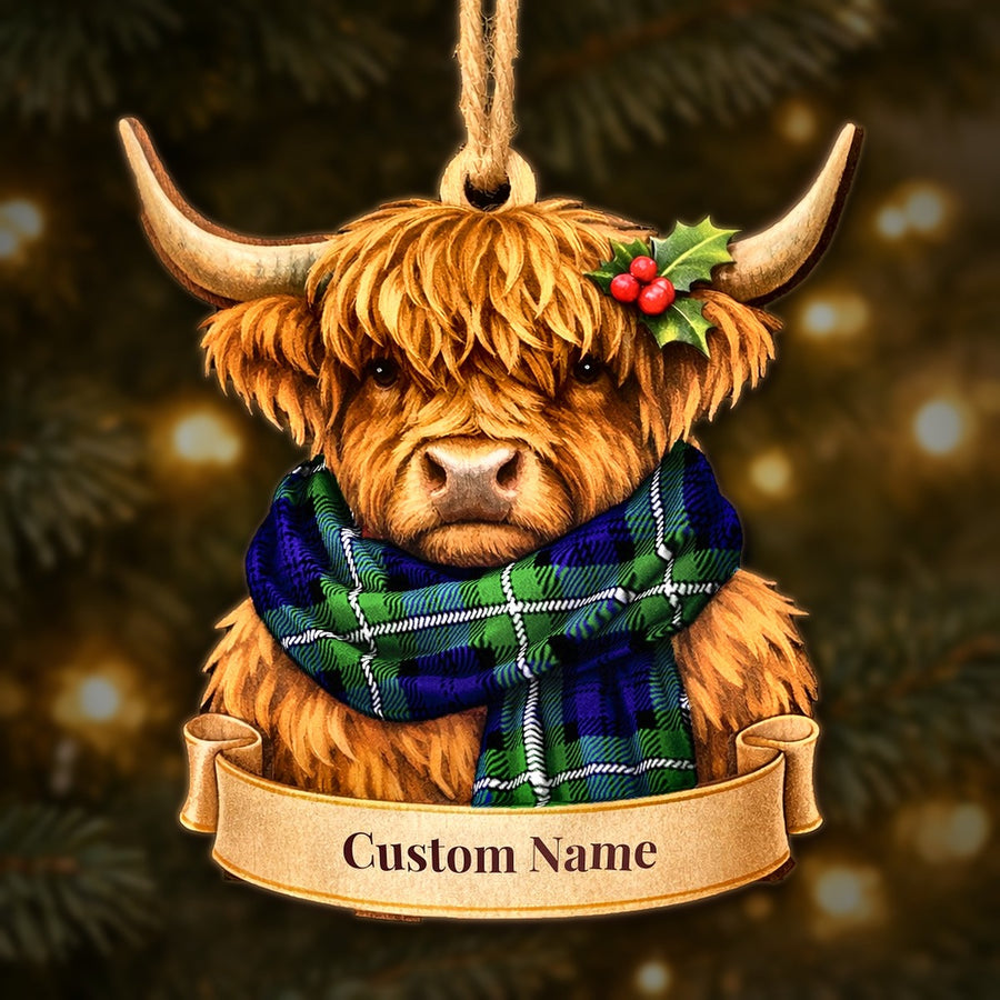 Wooden Highland cow Christmas ornament wearing a Forbes Modern tartan scarf, with a ribbon banner for a custom name