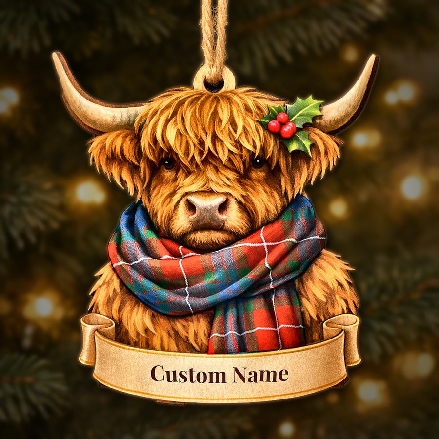 Wooden Highland cow Christmas ornament wearing a Fraser Ancient tartan scarf, with a ribbon banner for a custom name