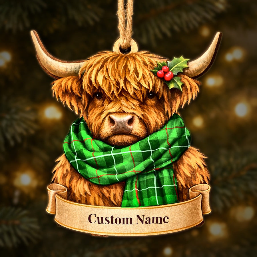 Wooden Highland cow Christmas ornament wearing a Galloway District tartan scarf, with a ribbon banner for a custom name