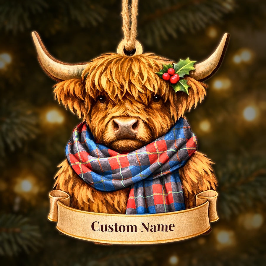 Wooden Highland cow Christmas ornament wearing a Galloway Red tartan scarf, with a ribbon banner for a custom name