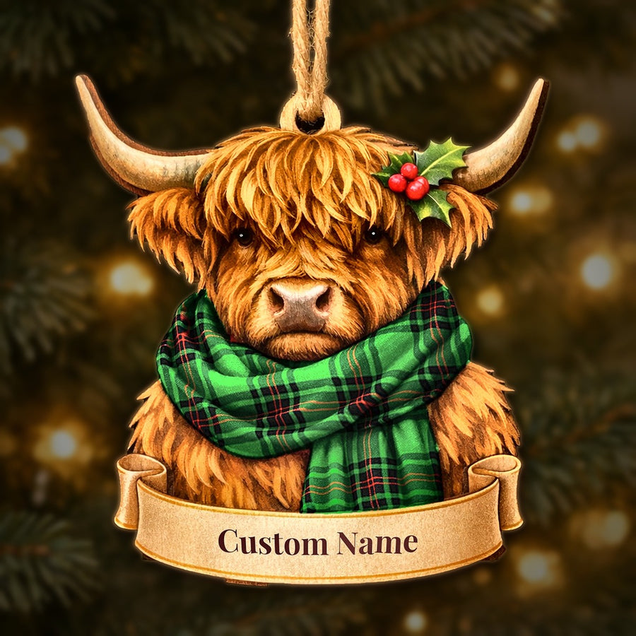 Wooden Highland cow Christmas ornament wearing a Ged tartan scarf, with a ribbon banner for a custom name