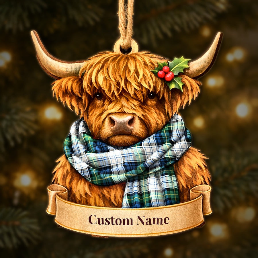 Wooden Highland cow Christmas ornament wearing a Gordon Dress Ancient tartan scarf, with a ribbon banner for a custom name