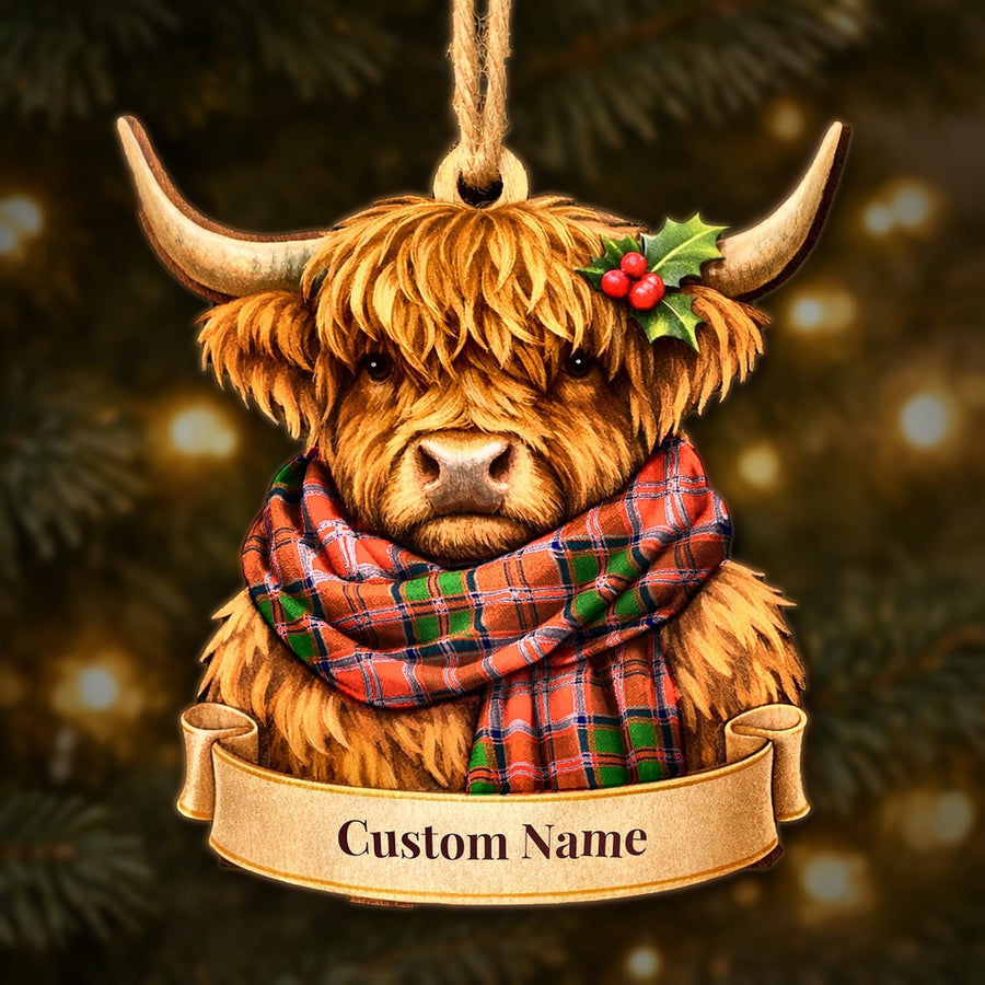 Wooden Highland cow Christmas ornament wearing a Grant Modern tartan scarf, with a ribbon banner for a custom name