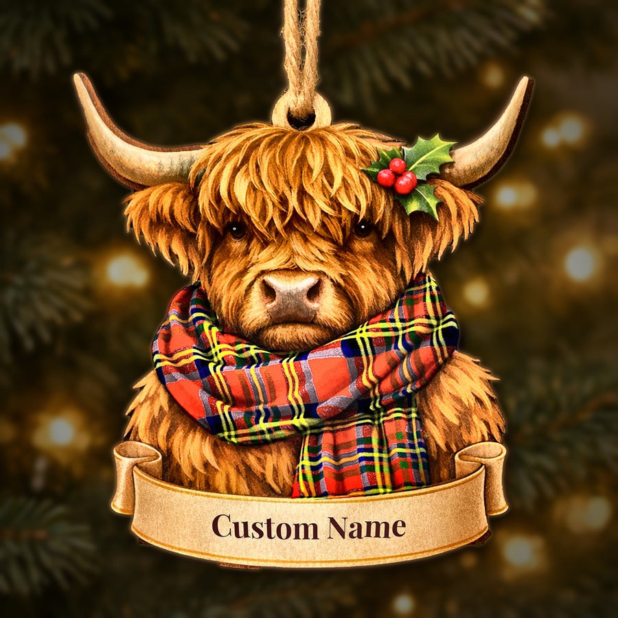 Wooden Highland cow Christmas ornament wearing a Hepburn tartan scarf, with a ribbon banner for a custom name