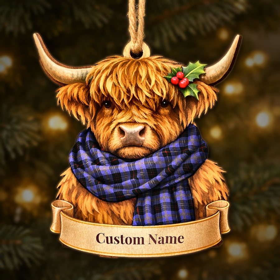 Wooden Highland cow Christmas ornament wearing a Horsburgh tartan scarf, with a ribbon banner for a custom name