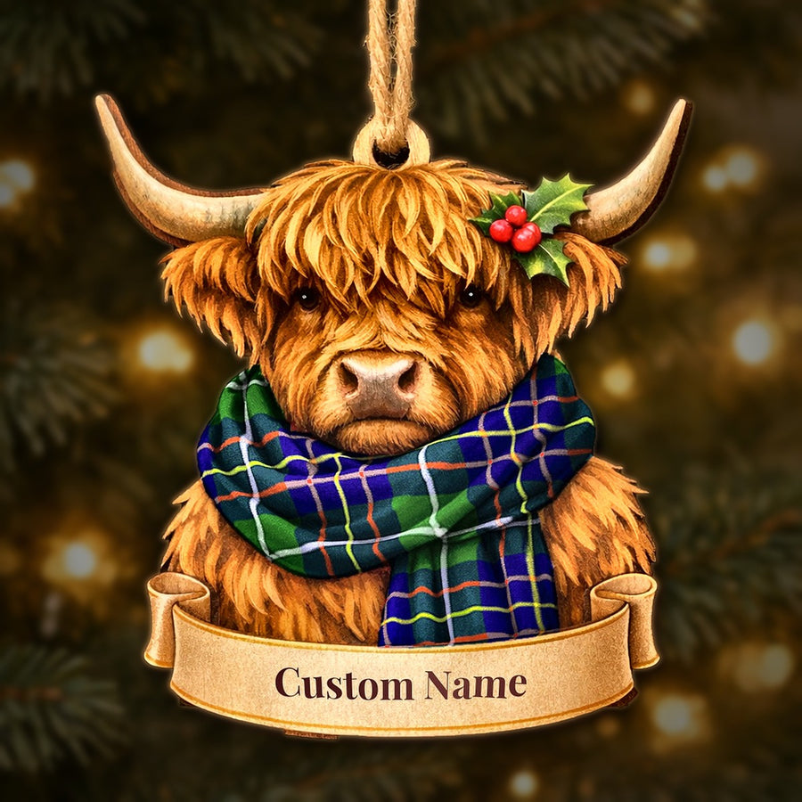 Wooden Highland cow Christmas ornament wearing a Inglis Modern tartan scarf, with a ribbon banner for a custom name