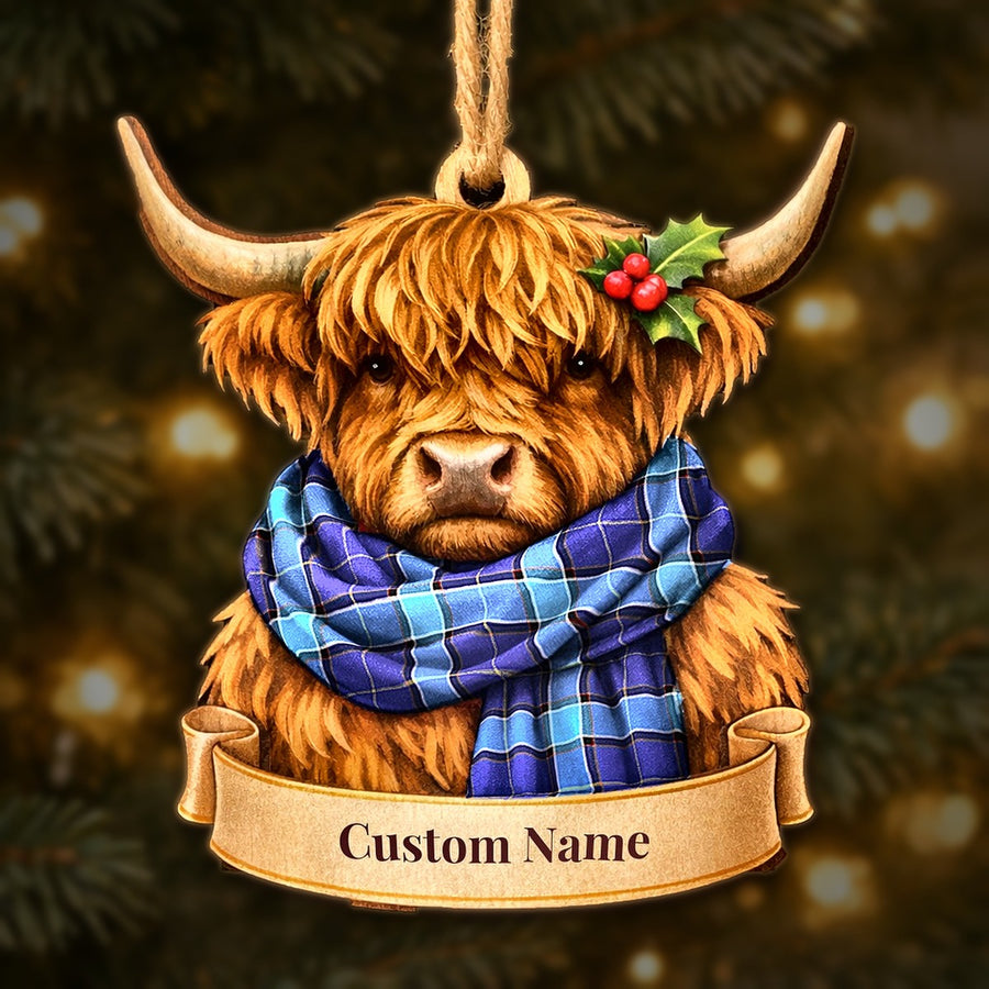 Wooden Highland cow Christmas ornament wearing a Kirkcaldy tartan scarf, with a ribbon banner for a custom name