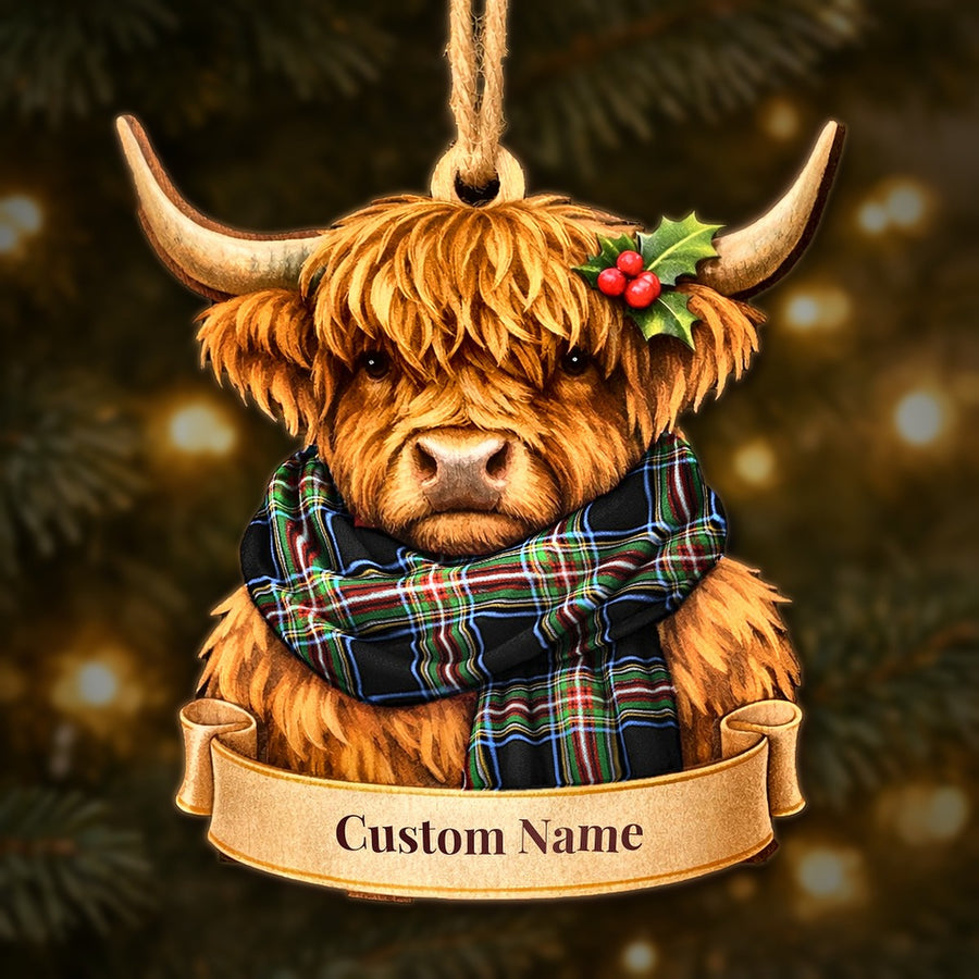 Wooden Highland cow Christmas ornament wearing a Lyle tartan scarf, with a ribbon banner for a custom name