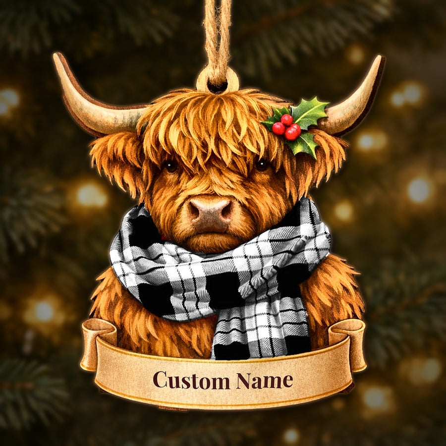 Wooden Highland cow Christmas ornament wearing a MacFarlane Black & White tartan scarf, with a ribbon banner for a custom name