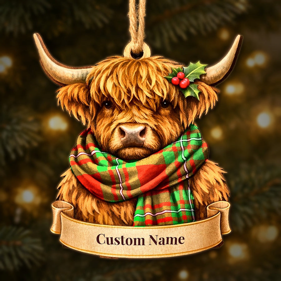 Wooden Highland cow Christmas ornament wearing a MacGregor Modern tartan scarf, with a ribbon banner for a custom name