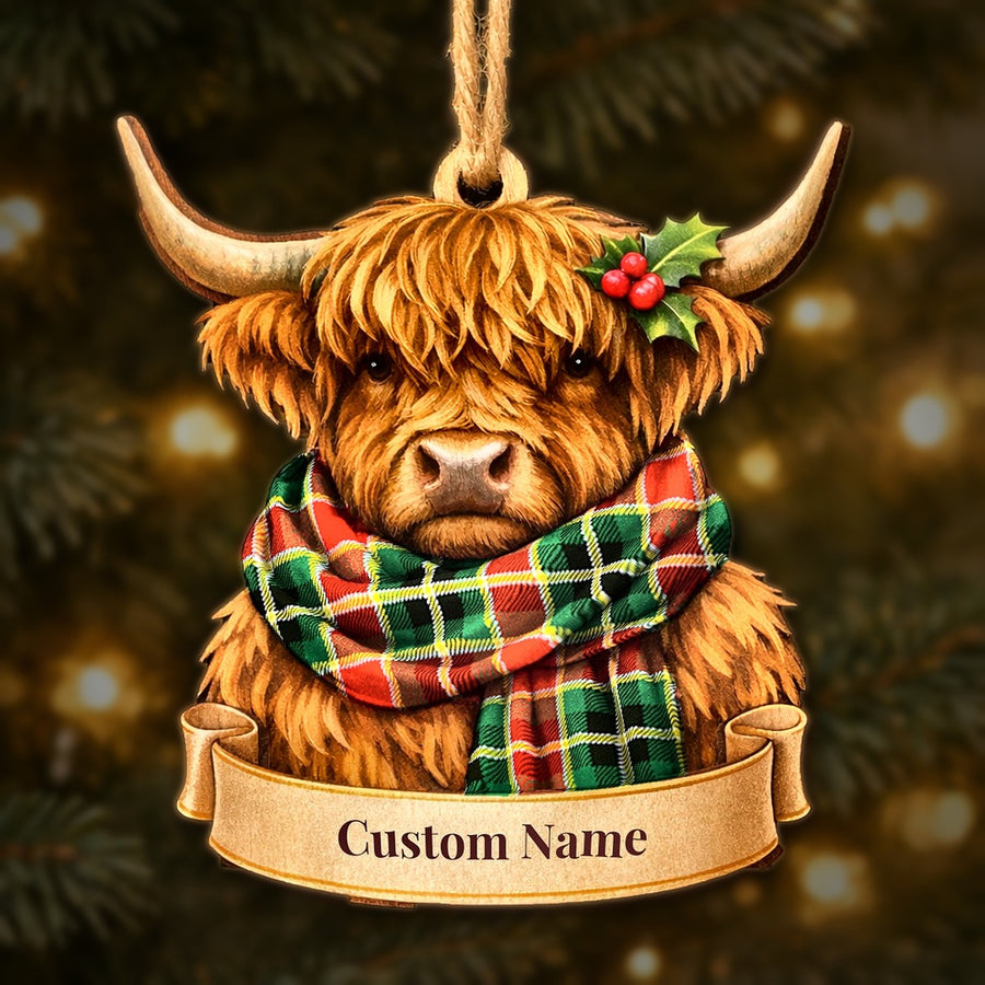 Wooden Highland cow Christmas ornament wearing a MacLachlan Hunting Modern tartan scarf, with a ribbon banner for a custom name