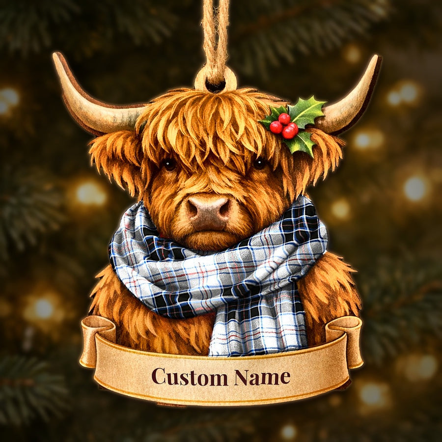 Wooden Highland cow Christmas ornament wearing a MacRae Dress Modern tartan scarf, with a ribbon banner for a custom name