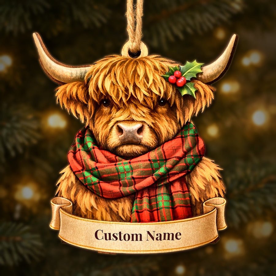 Wooden Highland cow Christmas ornament wearing a Maxwell tartan scarf, with a ribbon banner for a custom name