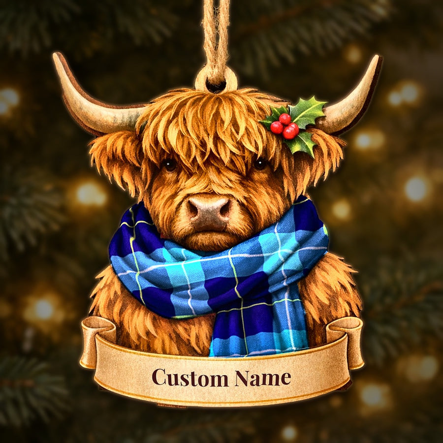 Wooden Highland cow Christmas ornament wearing a McKerrell tartan scarf, with a ribbon banner for a custom name