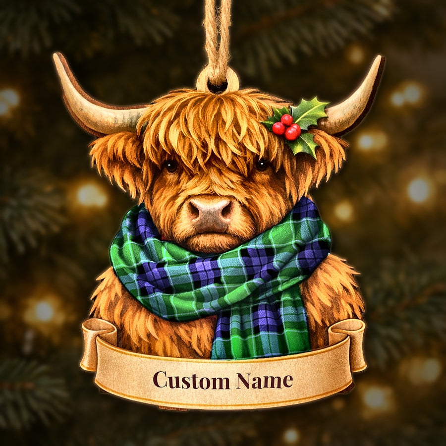 Wooden Highland cow Christmas ornament wearing a Monteith tartan scarf, with a ribbon banner for a custom name