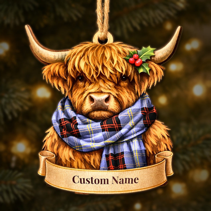 Wooden Highland cow Christmas ornament wearing a Rutherford tartan scarf, with a ribbon banner for a custom name