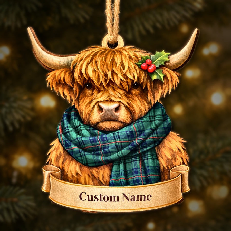 Wooden Highland cow Christmas ornament wearing a Walker tartan scarf, with a ribbon banner for a custom name