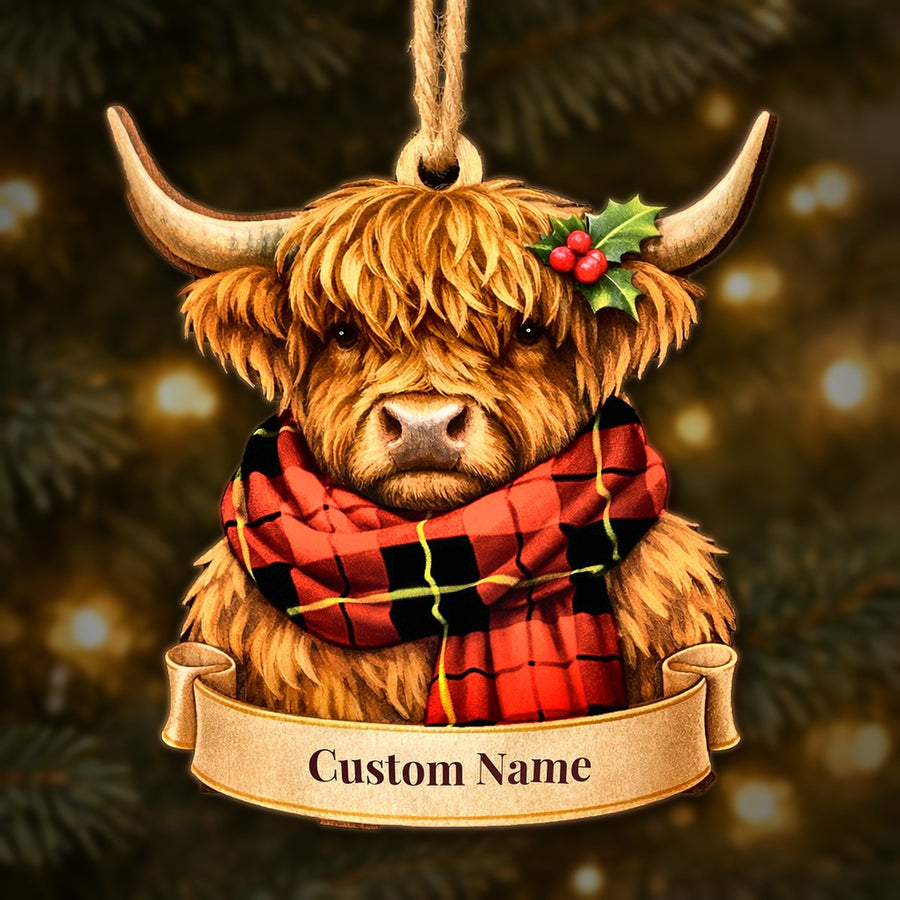Wooden Highland cow Christmas ornament wearing a Wallace Hunting Red tartan scarf, with a ribbon banner for a custom name
