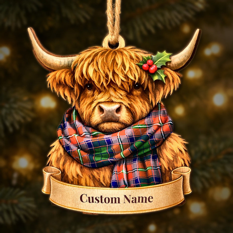 Wooden Highland cow Christmas ornament wearing a Wauchope tartan scarf, with a ribbon banner for a custom name