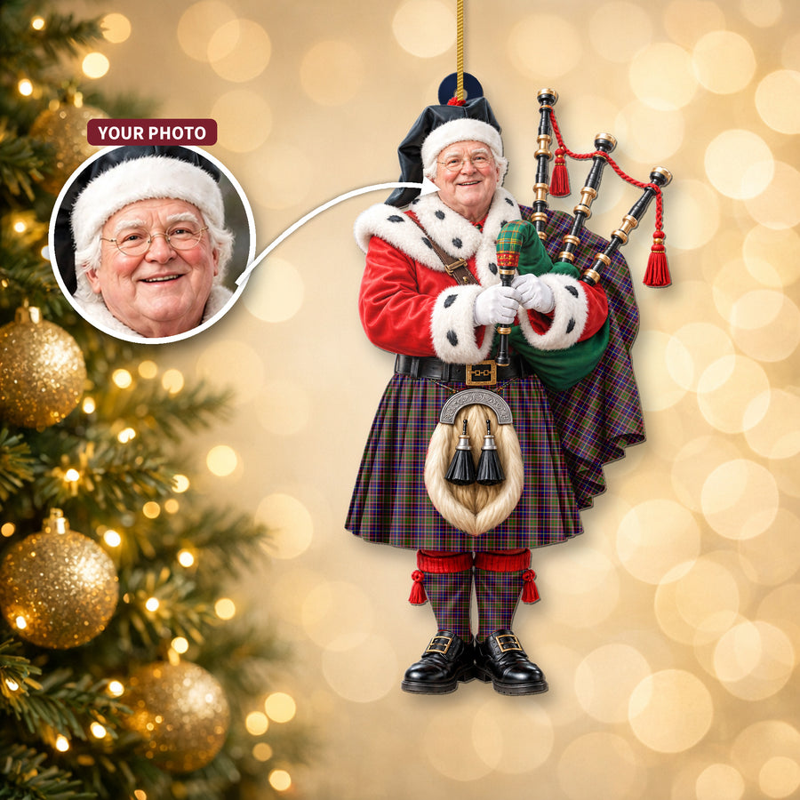 Christmas piper ornament in the Aikenhead tartan hanging on a Christmas tree, with the customer photo used for the face