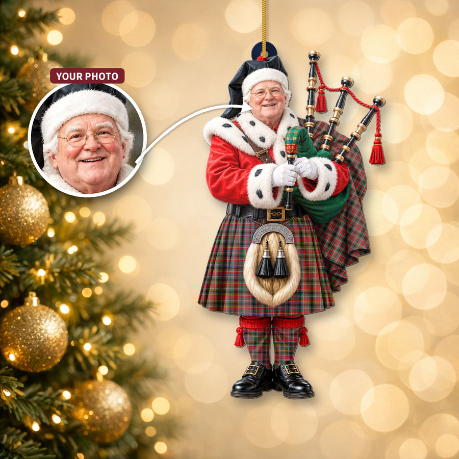Christmas piper ornament in the Anderson of Arbrake tartan hanging on a Christmas tree, with the customer photo used for the face