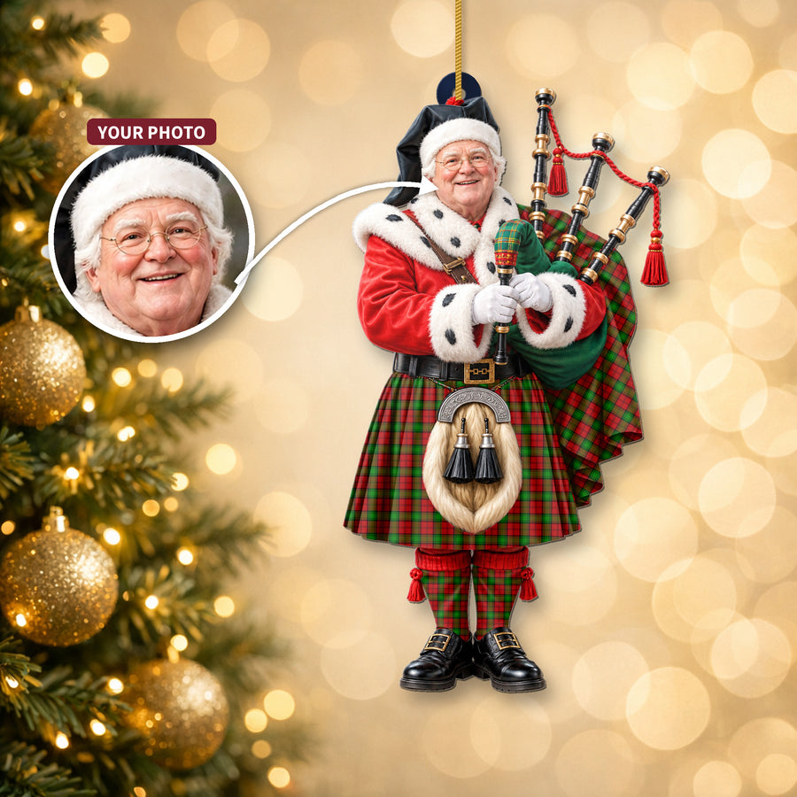 Christmas piper ornament in the Auchinleck tartan hanging on a Christmas tree, with the customer photo used for the face