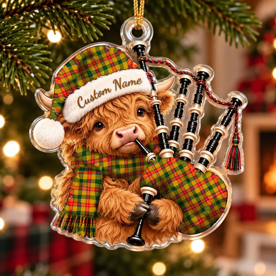 Acrylic Highland cow calf ornament playing the bagpipes, in a Baxter tartan Santa hat, scarf and pipe bag, with a custom name on the hat