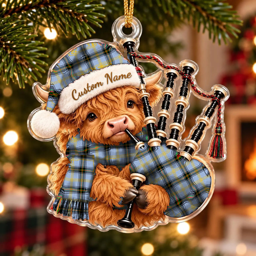Acrylic Highland cow calf ornament playing the bagpipes, in a Bell of the Borders tartan Santa hat, scarf and pipe bag, with a custom name on the hat