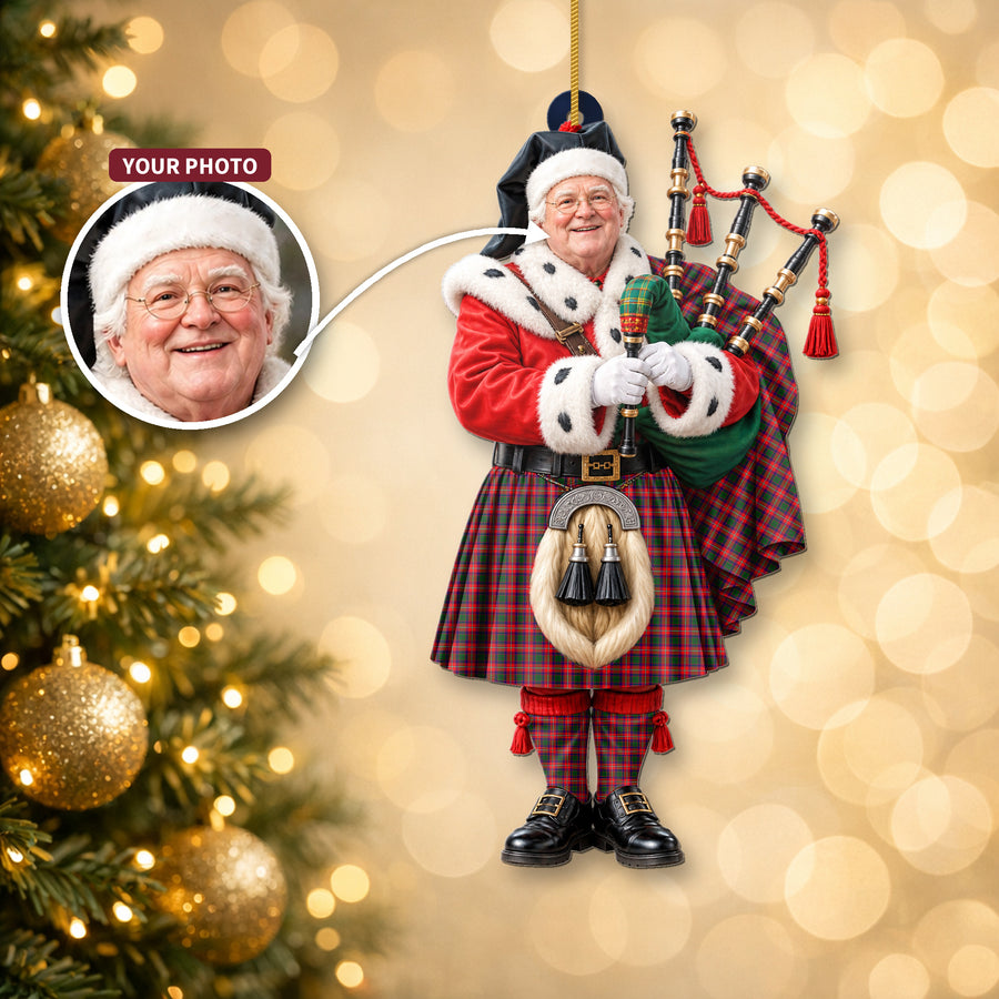 Christmas piper ornament in the Belshes tartan hanging on a Christmas tree, with the customer photo used for the face