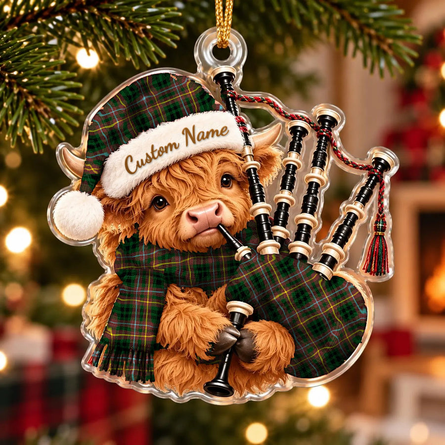 Acrylic Highland cow calf ornament playing the bagpipes, in a Buchanan Hunting tartan Santa hat, scarf and pipe bag, with a custom name on the hat