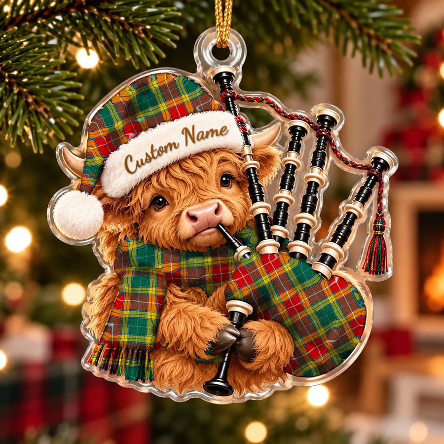 Acrylic Highland cow calf ornament playing the bagpipes, in a Buchanan Old Sett tartan Santa hat, scarf and pipe bag, with a custom name on the hat