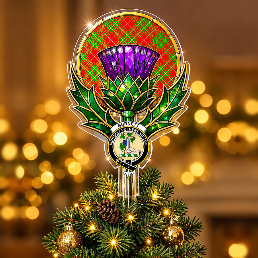 Clan Burnett crest in the centre of a stained-glass style thistle Christmas tree topper with the Burnett Ancient tartan behind the thistle