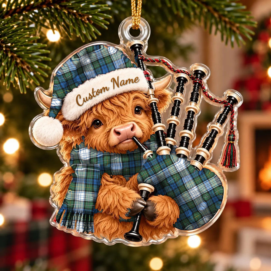 Acrylic Highland cow calf ornament playing the bagpipes, in a Campbell Dress Ancient tartan Santa hat, scarf and pipe bag, with a custom name on the hat