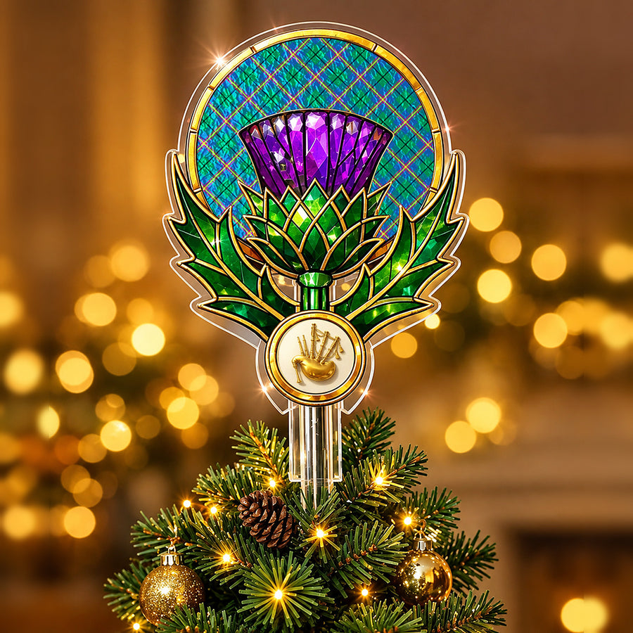 Stained-glass style thistle Christmas tree topper with a gold bagpipe emblem and the Carmichael Ancient tartan behind the thistle