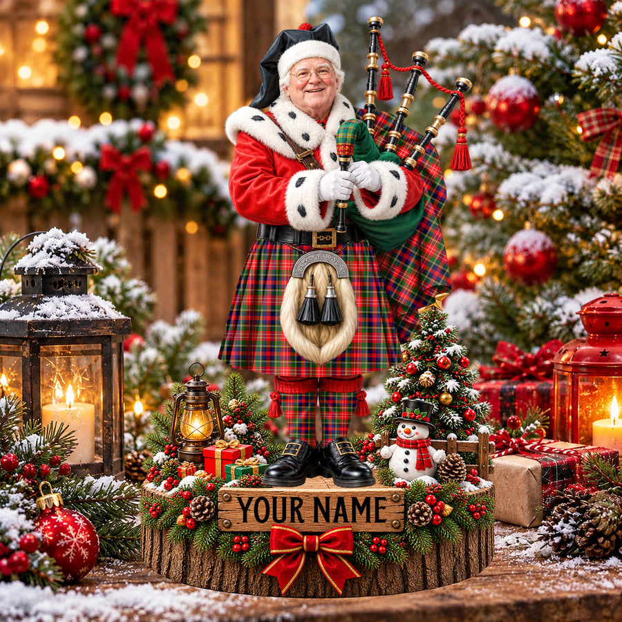 Personalized Christmas piper plaque in the Christie tartan, standing on a snowy log base with a name plaque