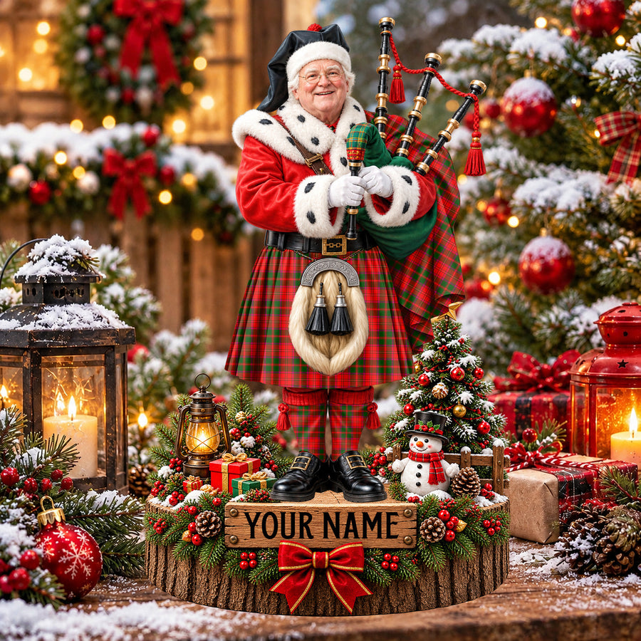 Personalized Christmas piper plaque in the Crief District tartan, standing on a snowy log base with a name plaque