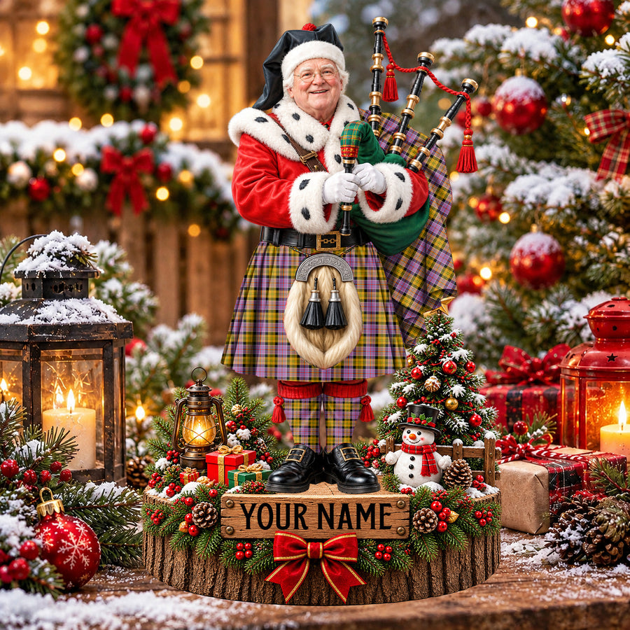 Personalized Christmas piper plaque in the Culloden Ancient tartan, standing on a snowy log base with a name plaque