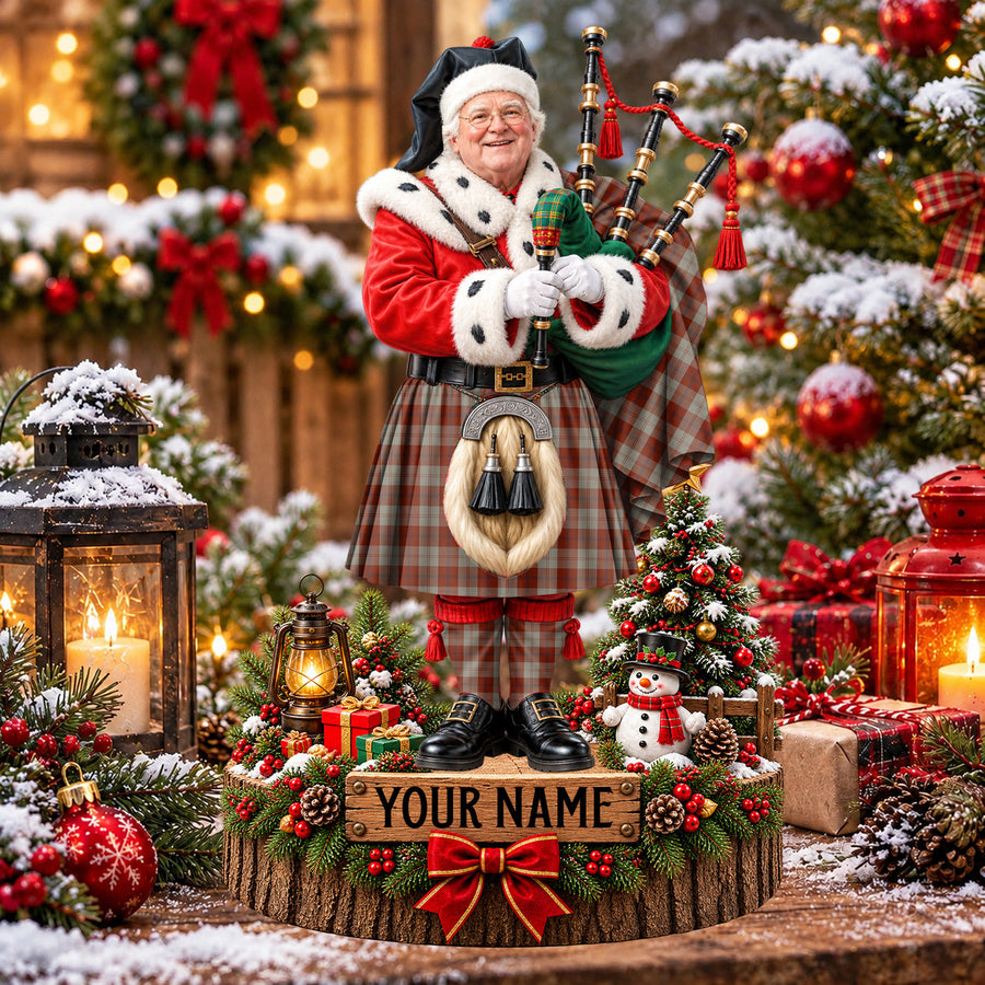 Personalized Christmas piper plaque in the Davidson Dress Dancers tartan, standing on a snowy log base with a name plaque