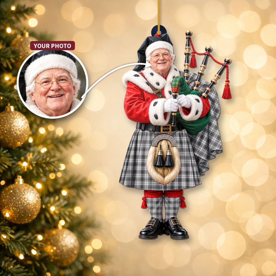Christmas piper ornament in the Douglas Grey Modern tartan hanging on a Christmas tree, with the customer photo used for the face