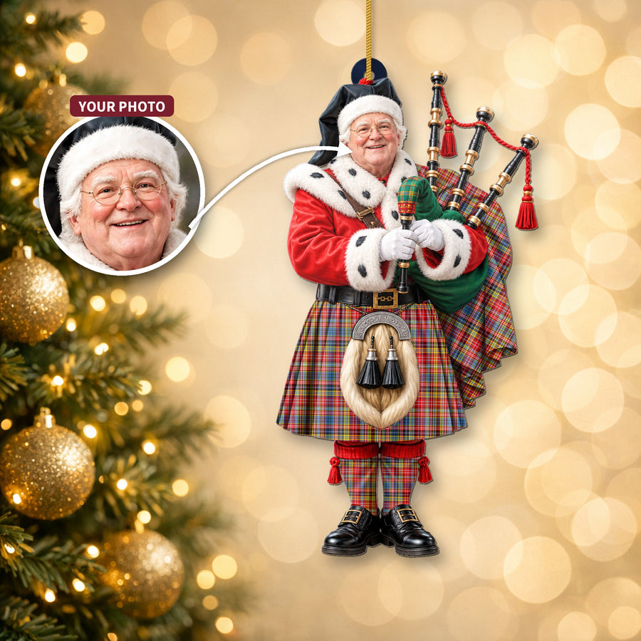 Christmas piper ornament in the Drummond of Strathallan tartan hanging on a Christmas tree, with the customer photo used for the face