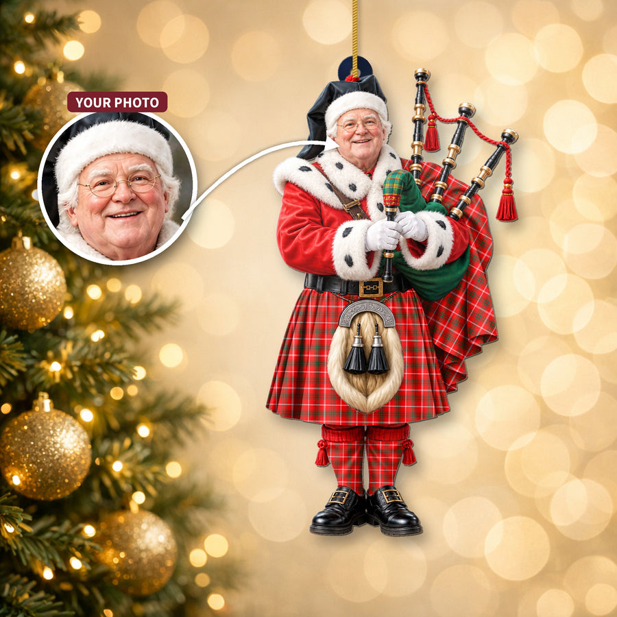 Christmas piper ornament in the Duke of Rothesay Modern tartan hanging on a Christmas tree, with the customer photo used for the face