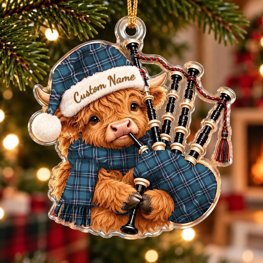 Acrylic Highland cow calf ornament playing the bagpipes, in a Earl of St Andrews tartan Santa hat, scarf and pipe bag, with a custom name on the hat