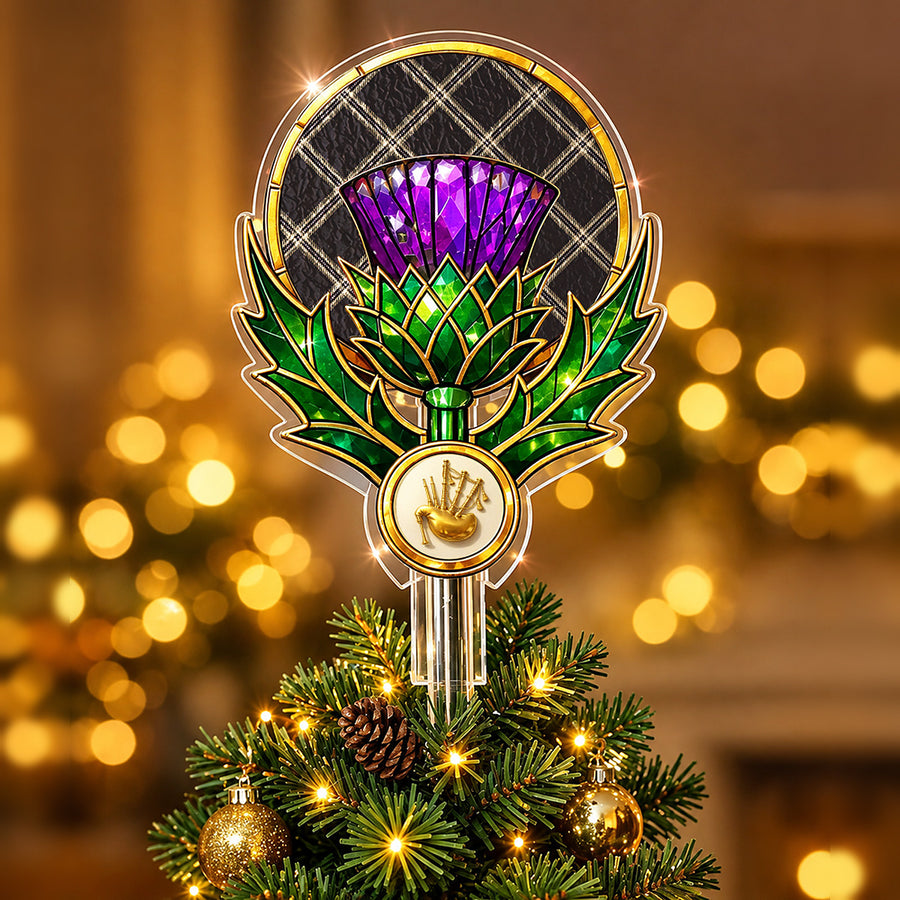 Stained-glass style thistle Christmas tree topper with a gold bagpipe emblem and the Eternity tartan behind the thistle