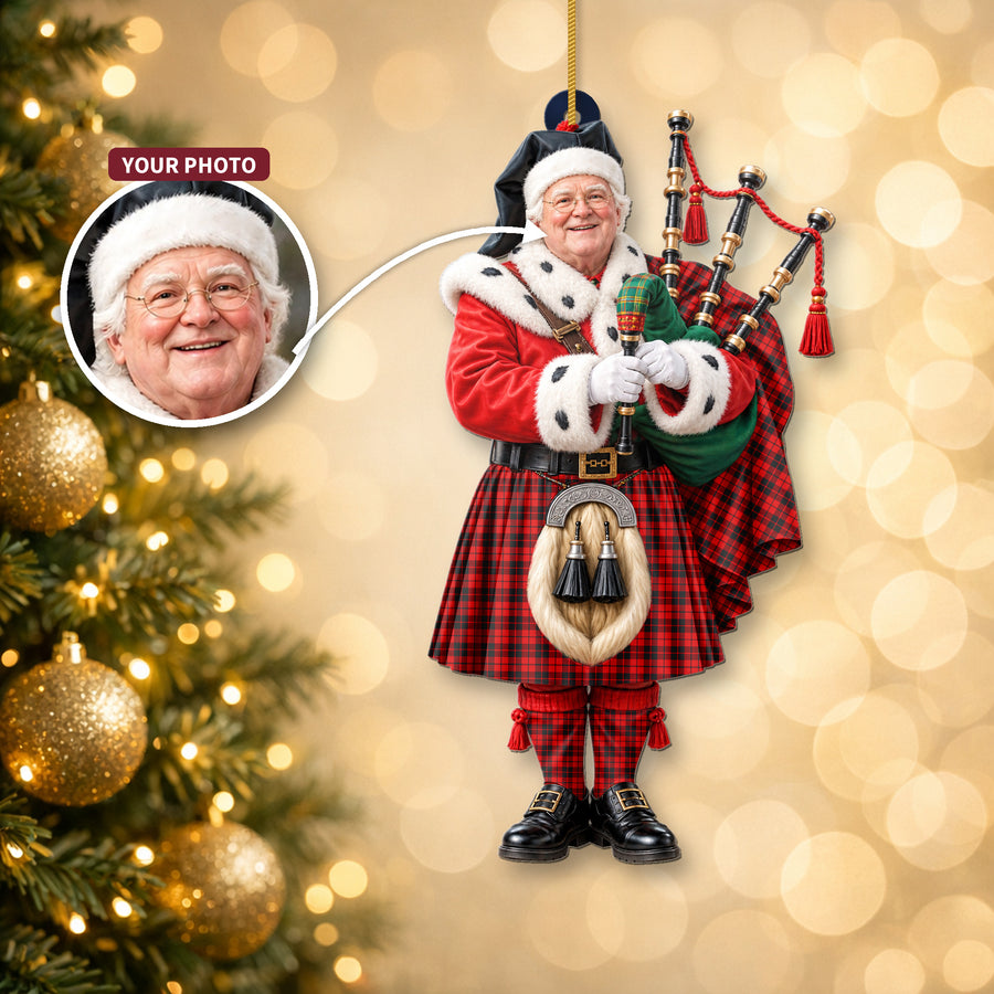 Christmas piper ornament in the Ettrick District tartan hanging on a Christmas tree, with the customer photo used for the face