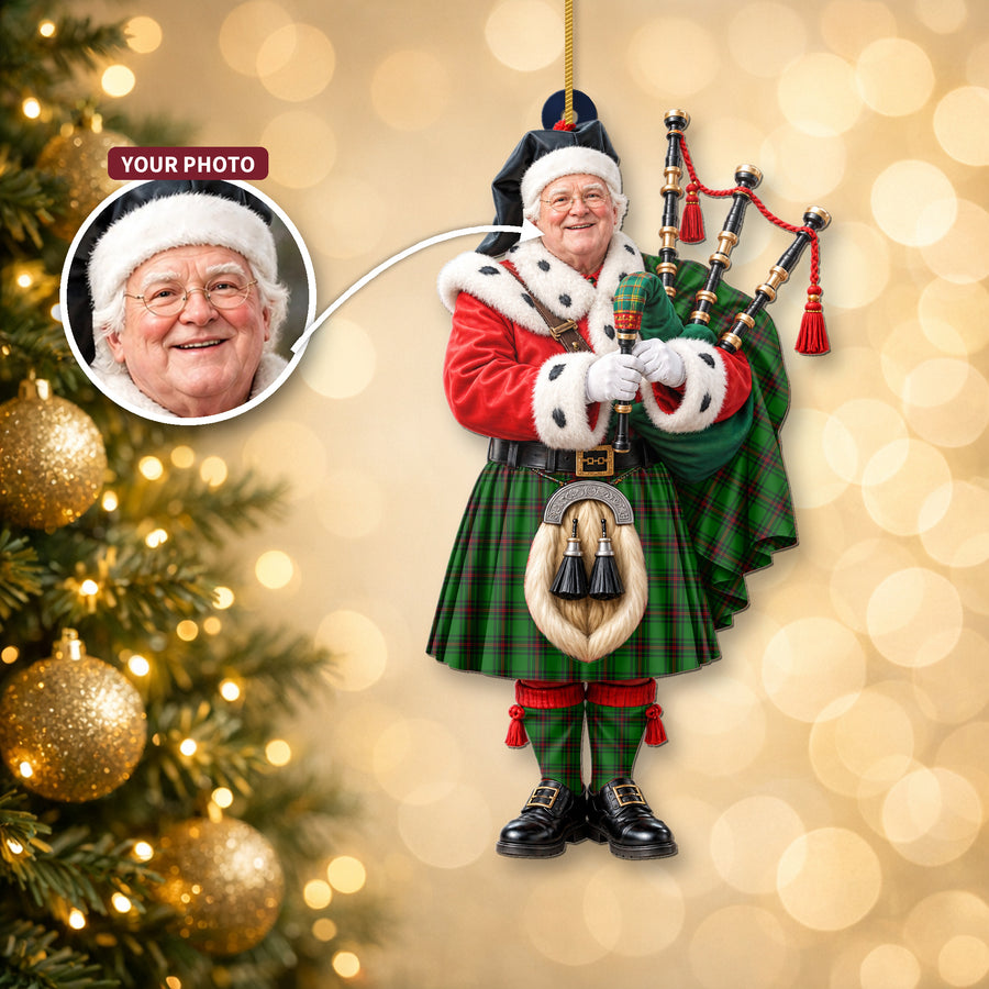 Christmas piper ornament in the Fife District tartan hanging on a Christmas tree, with the customer photo used for the face