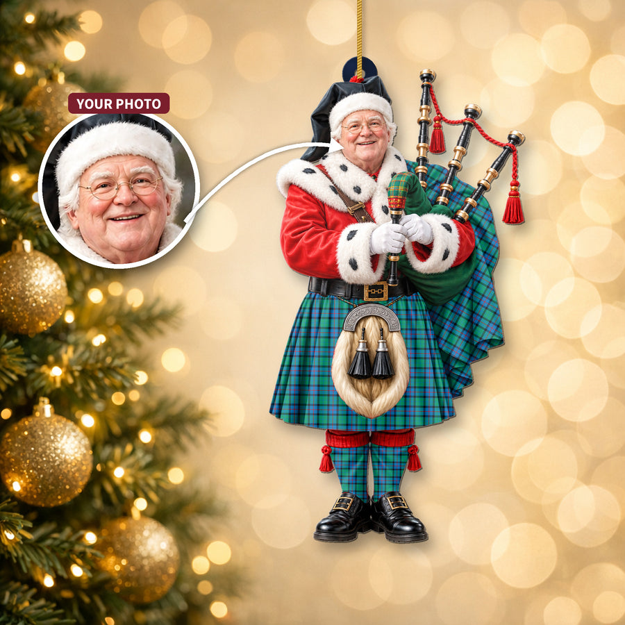 Christmas piper ornament in the Flower Of Scotland tartan hanging on a Christmas tree, with the customer photo used for the face