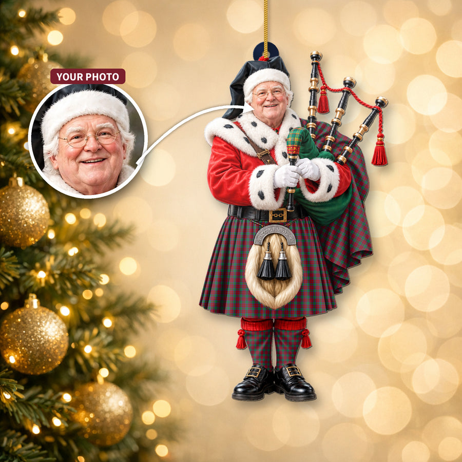 Christmas piper ornament in the Fotheringham tartan hanging on a Christmas tree, with the customer photo used for the face