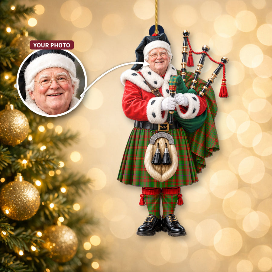 Christmas piper ornament in the Fulton tartan hanging on a Christmas tree, with the customer photo used for the face